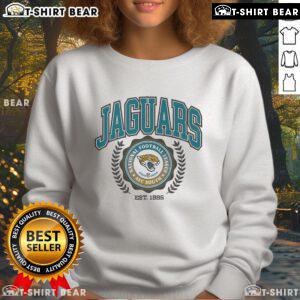 Alt Text: Jacksonville Jaguars team crest sweatshirt established 1995, featuring the iconic logo and vibrant team colors.