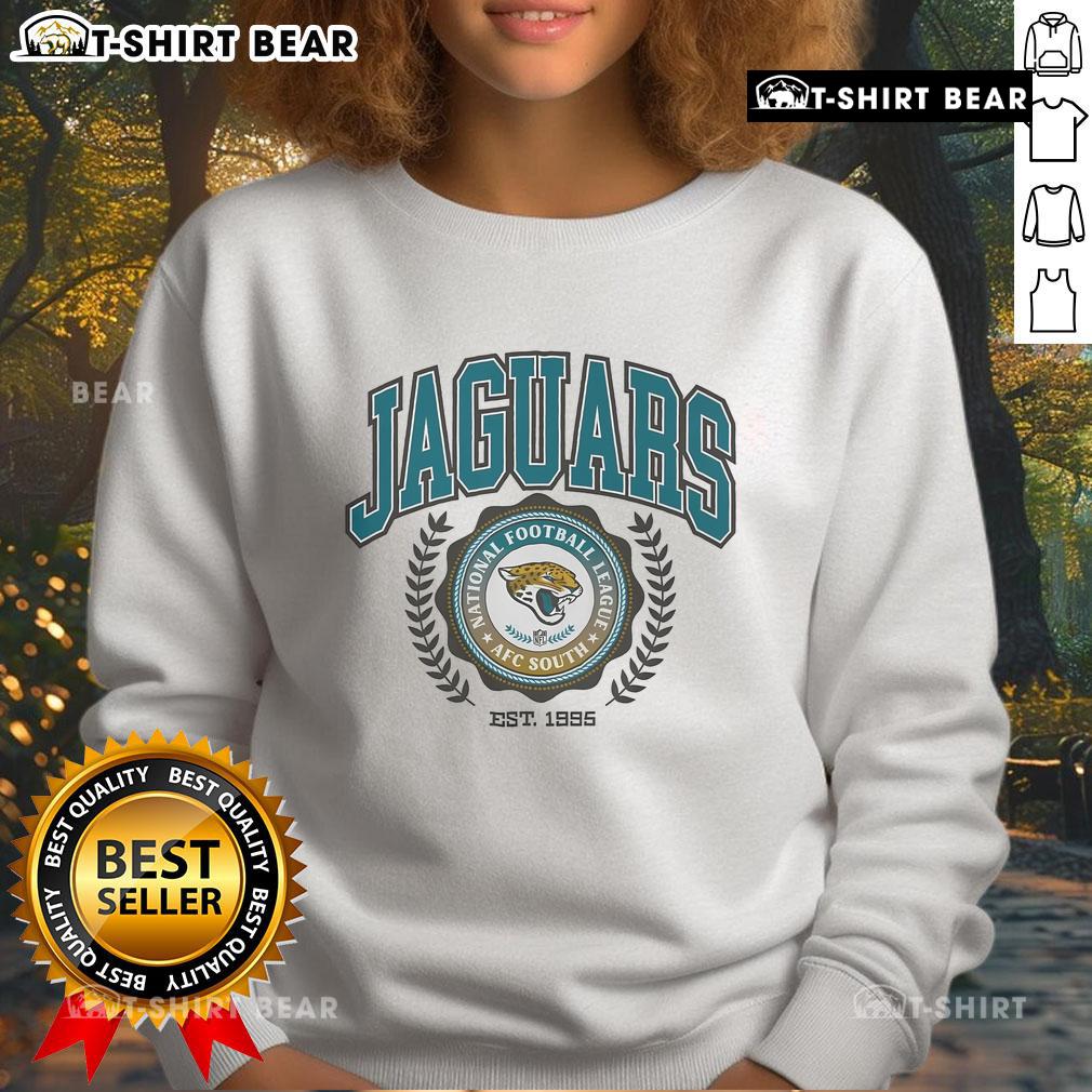 Alt Text: Jacksonville Jaguars team crest sweatshirt established 1995, featuring the iconic logo and vibrant team colors.