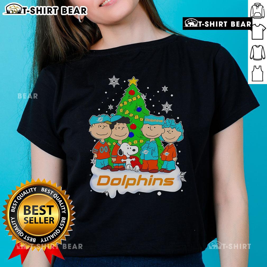 Top Peanuts characters on a Miami Dolphins Christmas tree ladies tee, perfect for festive NFL fans.