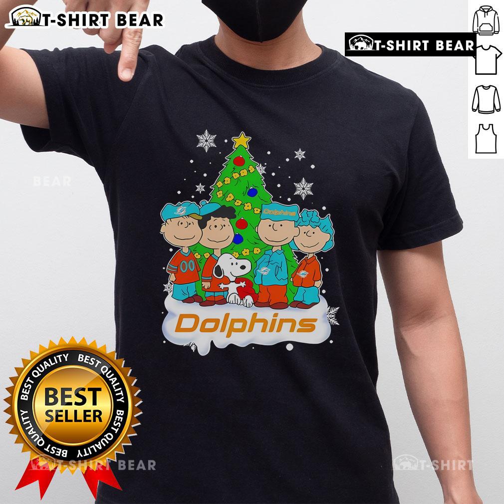 Top Peanuts characters on a Miami Dolphins Christmas tree T-shirt, perfect for festive fans and holiday cheer.