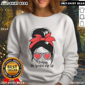 Alt Text: Spoiled wife wearing a messy bun in an Awesome S Rocking Spoiled Wife sweatshirt, showcasing relaxed style.