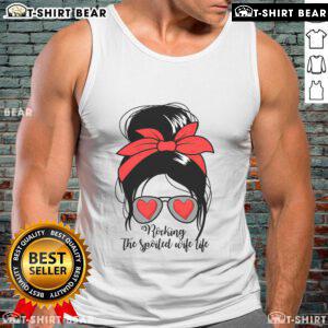 Stylish woman in a messy bun wearing a 'Spoiled Wife' tank top, embodying the awesome spoiled wife life.