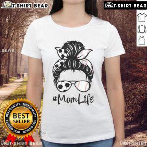 Mom wearing a cute tee with messy bun, enjoying soccer with kids, embodying the fun of cute mom life.