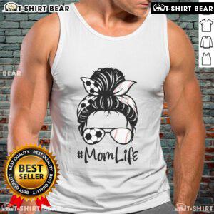 Mom in a tank top with 'Cute Mom Life' graphic, messy bun hairstyle, enjoying a soccer game with her kids.