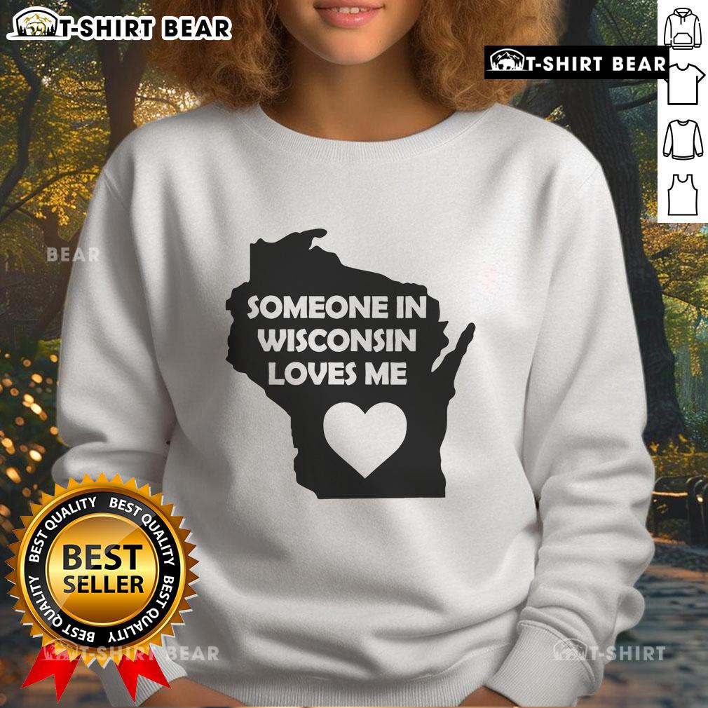 Cozy 'Good Someone in Wisconsin Loves Me' sweatshirt displayed on a wooden background, perfect for casual wear.