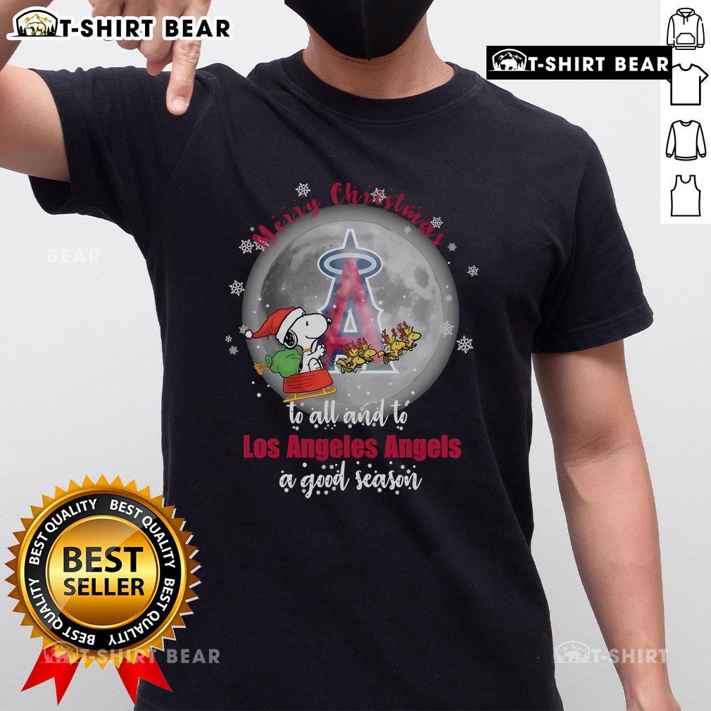 Santa Snoopy Merry Christmas T-Shirt featuring Los Angeles Angels logo for a joyful 2024 season celebration.