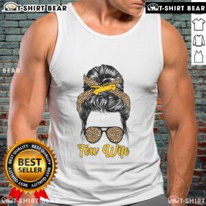Pretty tow truck wife in a messy bun wearing a stylish tank top, showcasing her love for the towing lifestyle.