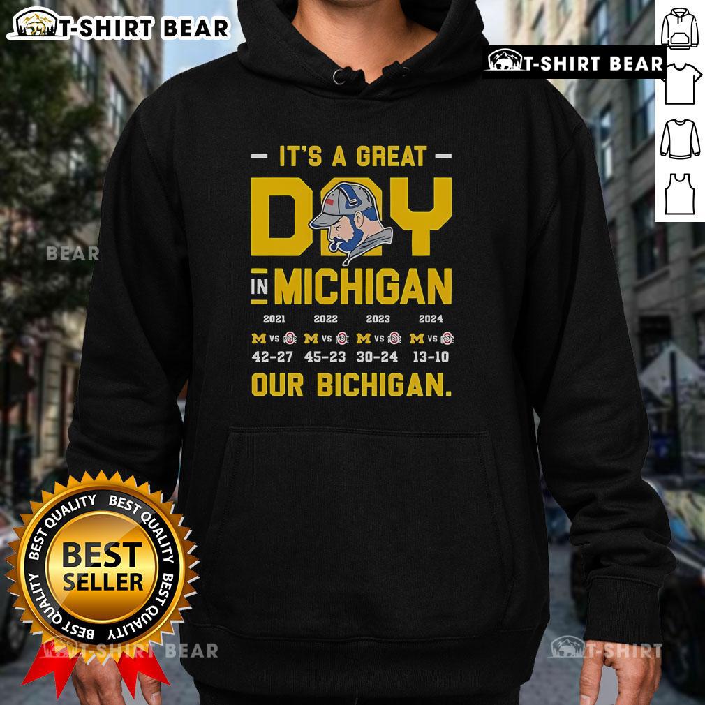 Person wearing a 'Bichigan' hoodie enjoying a sunny day in Michigan's outdoors, showcasing local pride and style.