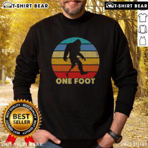 Vintage sunset sweatshirt featuring a unique Bigfoot prosthetic design for amputated disability awareness.