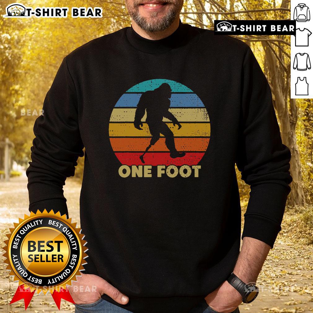 Vintage sunset sweatshirt featuring a unique Bigfoot prosthetic design for amputated disability awareness.