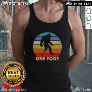 Vintage sunset tank top featuring a Bigfoot design, showcasing prosthetics for amputated disability awareness.