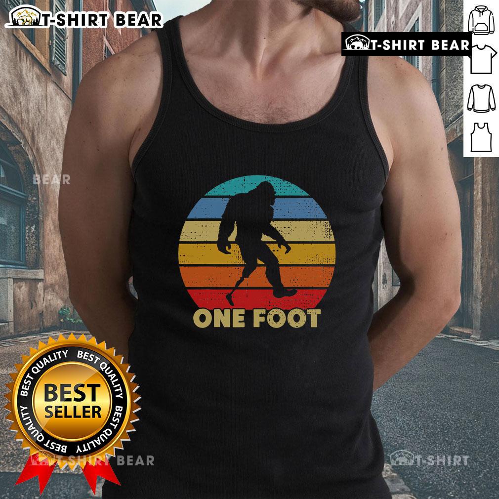Vintage sunset tank top featuring a Bigfoot design, showcasing prosthetics for amputated disability awareness.