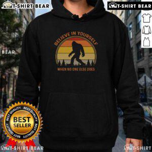 Vintage sunset hoodie featuring a Sasquatch design and 'Believe in Yourself' slogan, perfect for Bigfoot enthusiasts.