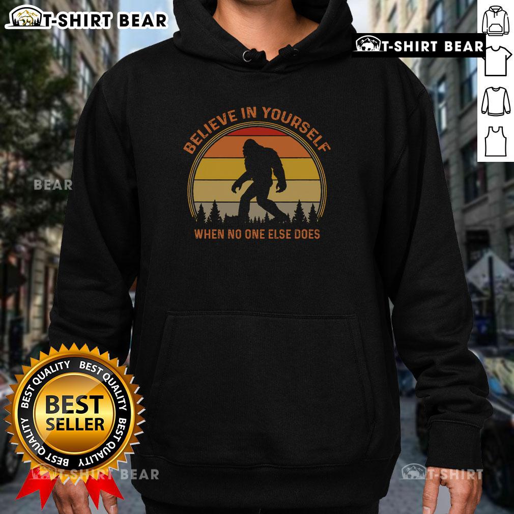 Vintage sunset hoodie featuring a Sasquatch design and 'Believe in Yourself' slogan, perfect for Bigfoot enthusiasts.