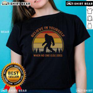 Vintage sunset ladies tee featuring Sasquatch and 'Believe in Yourself' slogan, perfect for Big Foot enthusiasts.