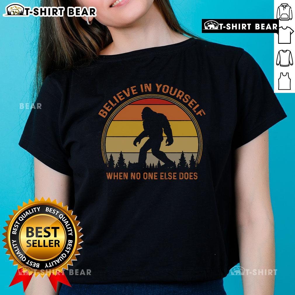Vintage sunset ladies tee featuring Sasquatch and 'Believe in Yourself' slogan, perfect for Big Foot enthusiasts.