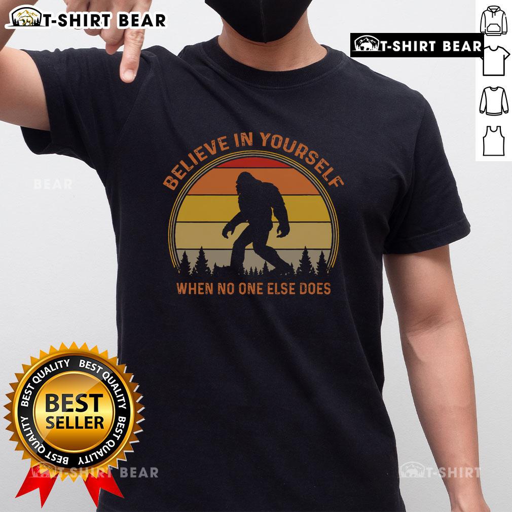 Vintage sunset t-shirt featuring a Sasquatch Big Foot graphic with 'Believe In Yourself' slogan for outdoor enthusiasts.