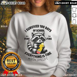 Nice raccoon wearing a 'I Survived 100 Days of School' sweatshirt, showcasing a fun and playful school spirit design.