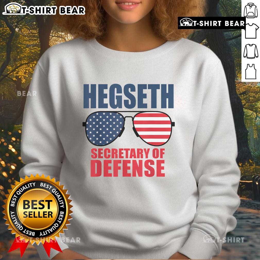 Top Hegseth Secretary of Defense wearing sunglasses in MAGA sweatshirt, showcasing Trump's pick for defense role.