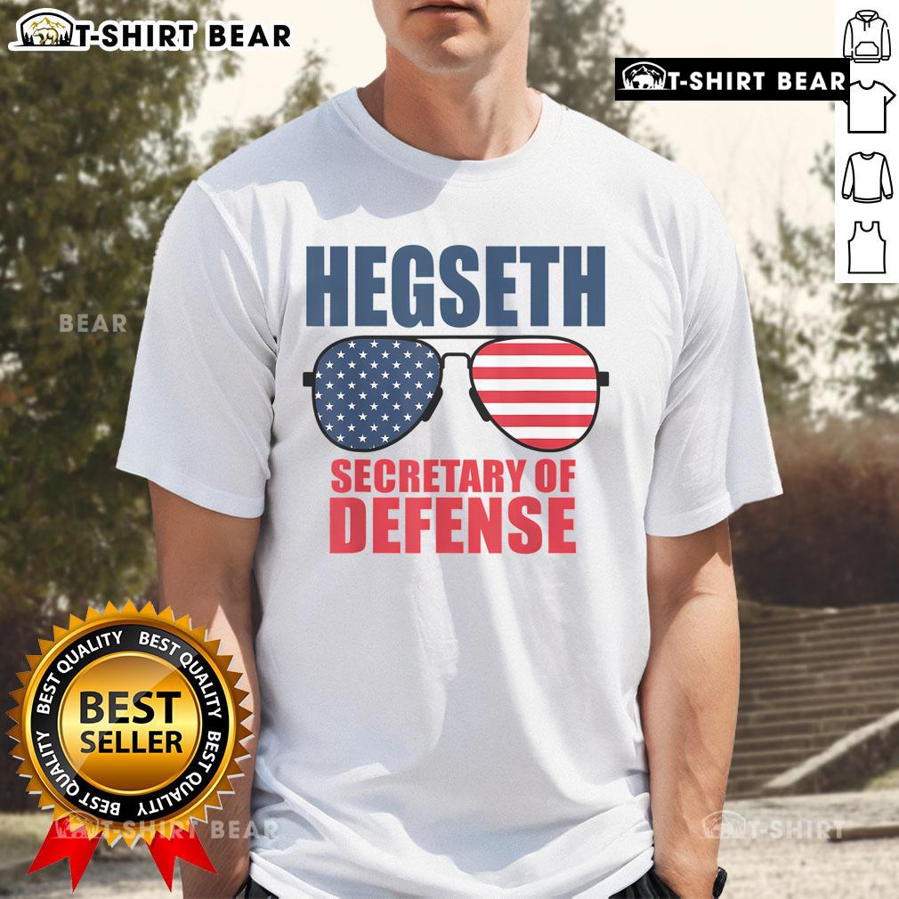 Alt Text: Top Hegseth Secretary of Defense sunglasses on a MAGA support T-shirt featuring Trumps pick for the role.
