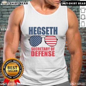 Top Hegseth wears sunglasses and a MAGA tank top, showcasing support for Trump as Secretary of Defense.