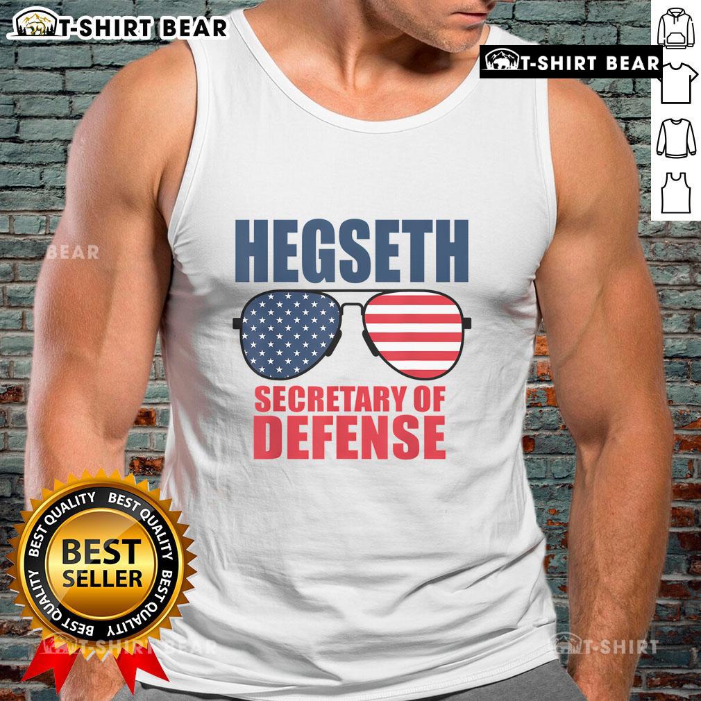 Top Hegseth wears sunglasses and a MAGA tank top, showcasing support for Trump as Secretary of Defense.