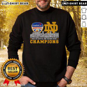Notre Dame Fighting Irish sweatshirt celebrating Capital One Orange Bowl Champions 2024-25 against a city skyline backdrop.