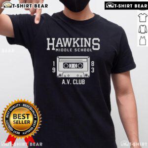 Alt Text: Official Hawkins Middle School AV Club T-Shirt featuring the iconic logo and design in vibrant colors.