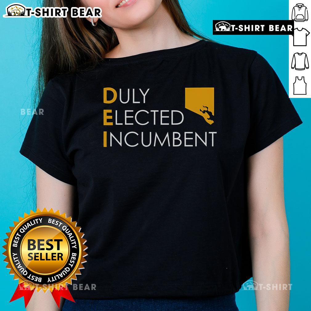 Alt Text: Official M. Scott wearing a Dei Duly Elected Incumbent Ladies Tee, showcasing style and commitment to leadership.