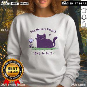 Cute cat sweatshirt featuring 'The Horrors Persist But So Do I' slogan, perfect for cozy casual wear.