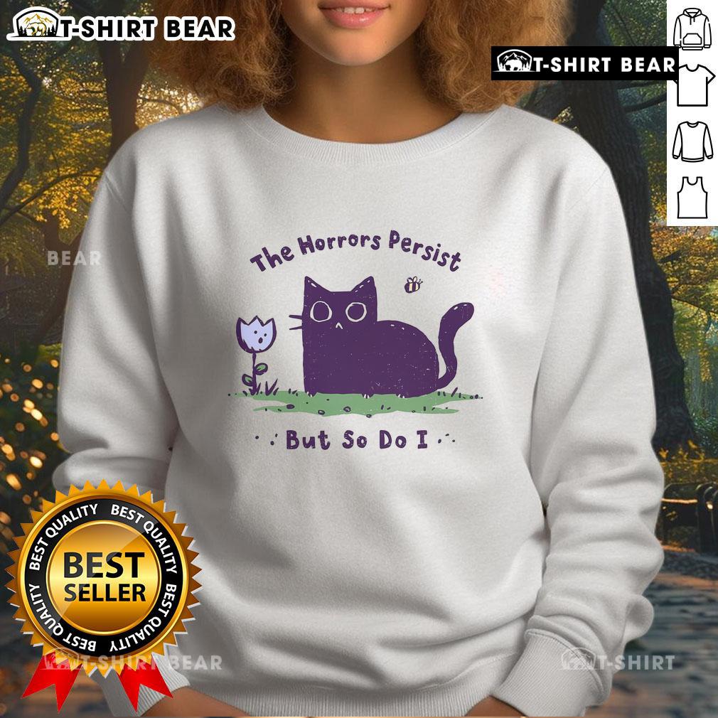 Cute cat sweatshirt featuring 'The Horrors Persist But So Do I' slogan, perfect for cozy casual wear.
