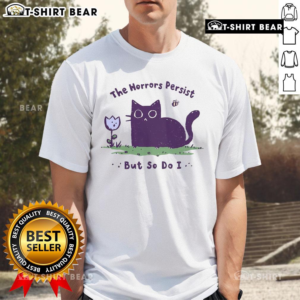 Premium The Horrors Persist But So Do I Cute Cat T-Shirt featuring a playful cat design and motivational text.