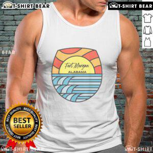 Sunset view over the Gulf of Mexico with a souvenir tank top showcasing Fort Morgan, Alabama's scenic beauty.