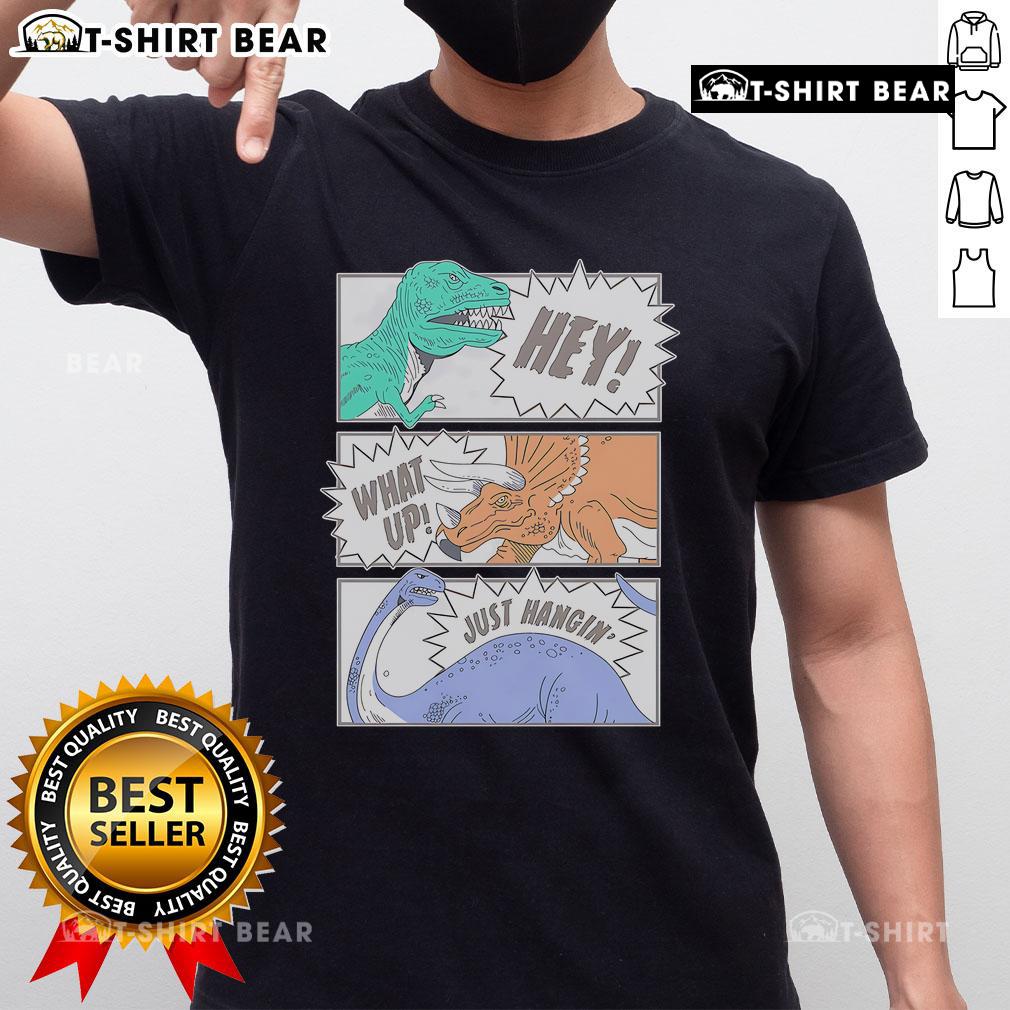 Alt Text: Top Hey What Up Just Hangin' Dinosaur Friends Club T-Shirt featuring colorful dinosaur graphics and playful text.