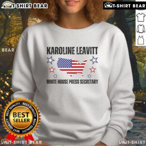 Karoline Leavitt wearing a White House Press Secretary sweatshirt, showcasing her style and political passion.