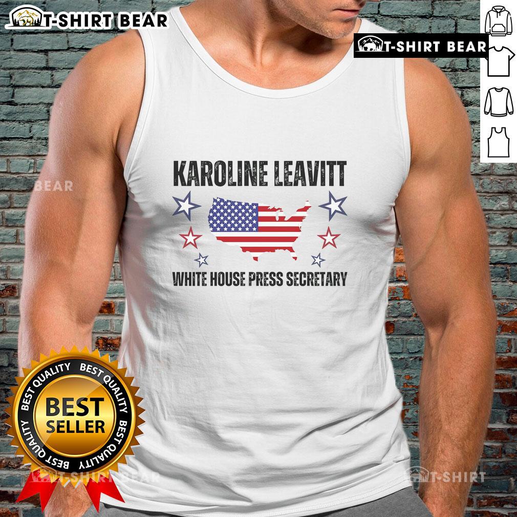 Karoline Leavitt, White House Press Secretary, in a stylish tank top, showcasing her confident presence at a press briefing.