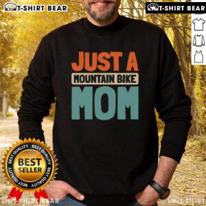 Mountain bike mom wearing a sweatshirt while biking on a trail, showcasing her passion for MTB and outdoor adventures.