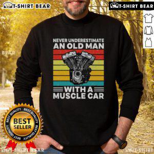 Top Never Underestimate An Old Man With A Muscle Car Sweatshirt worn by a man smiling in a vintage muscle car.