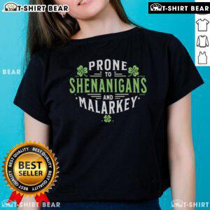 Top Prone to Shenanigans Malarkey Fun Clovers St. Patrick's Day Ladies Tee displayed on a vibrant green background.