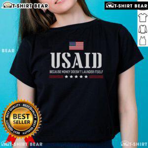 US Americans Ladies Tee featuring 'Top Usaid Because Money Doesn't Launder Itself' graphic design for stylish activism.