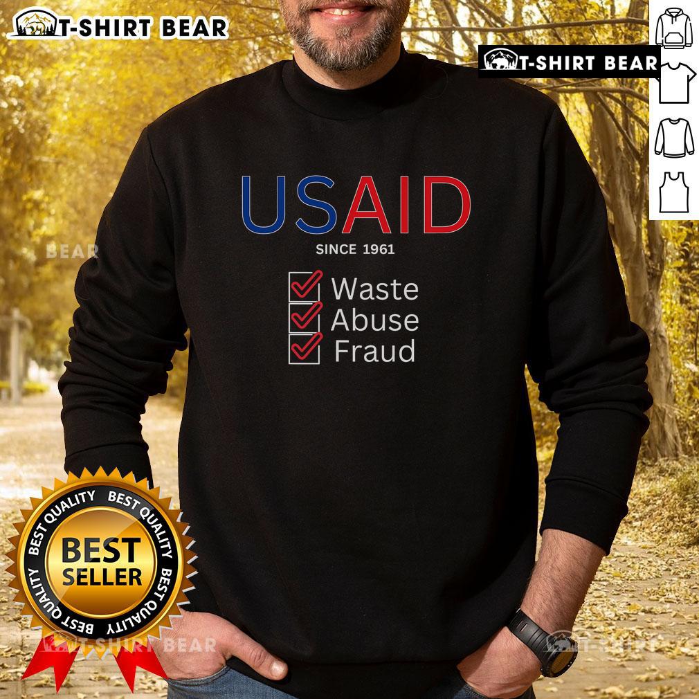 Top USAID Waste Abuse Fraud Checked Since 1961 Sweatshirt showcasing a bold design promoting accountability in aid.