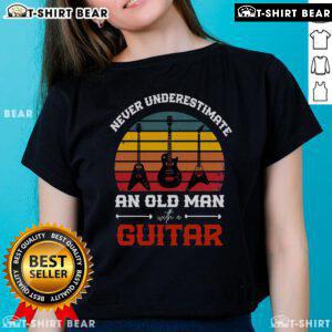 Cool musician wearing a vintage guitar tee, showcasing retro style and passion for music in a vibrant setting.