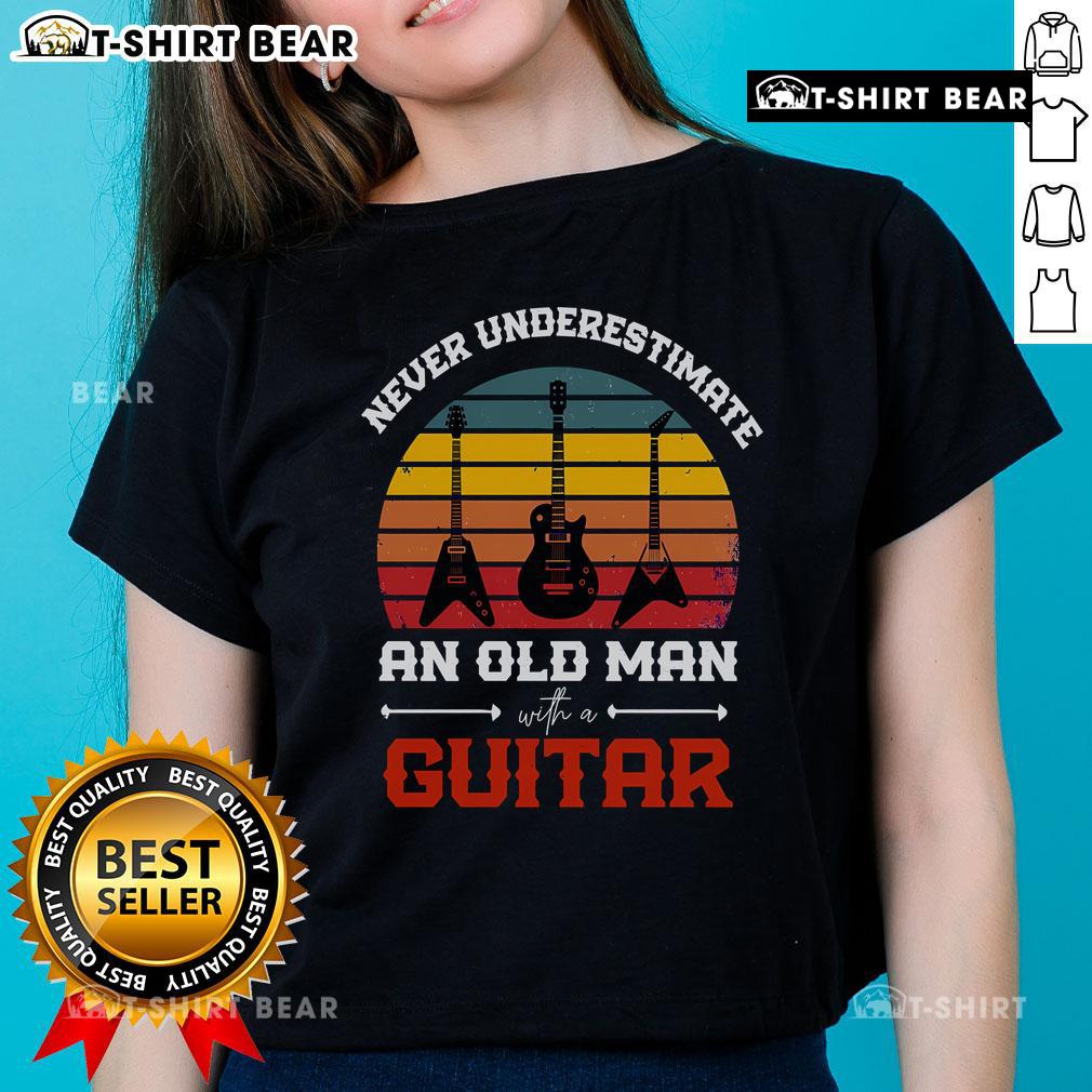 Cool musician wearing a vintage guitar tee, showcasing retro style and passion for music in a vibrant setting.