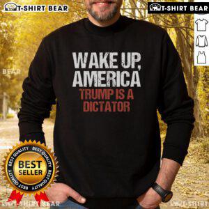 Protest sweatshirt reading 'Hot Wake Up America: Trump Is A Dictator' worn during a political demonstration.
