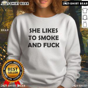 Official She Likes To Smoke And Fck Sweatshirt displayed on a hanger, showcasing trendy design and comfortable fit.