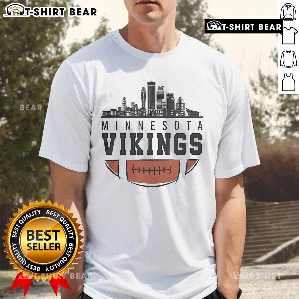 Alt Text: Premium NFL 2025 Minnesota Vikings T-shirt featuring a vibrant city skyline design for fans of American football.