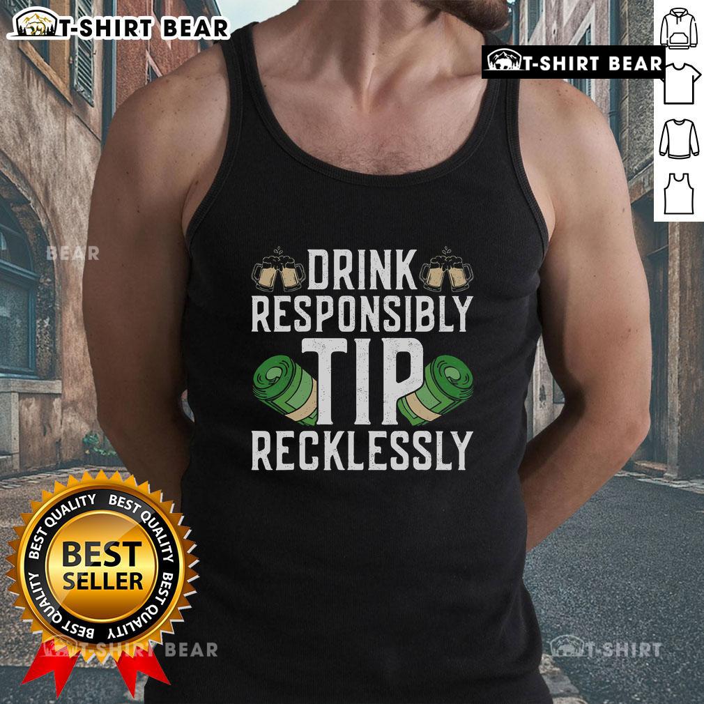 Top bartender mixologist wearing a humorous 'Drink Responsibly, Tip Recklessly' tank top at a vibrant bar.