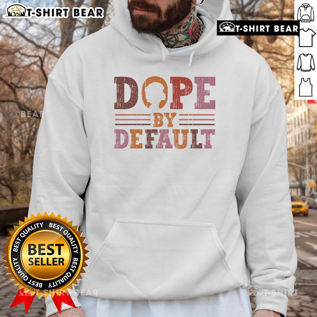 Stylish Black woman wearing a retro hoodie that reads 'Dope By Default,' celebrating Black history and culture.