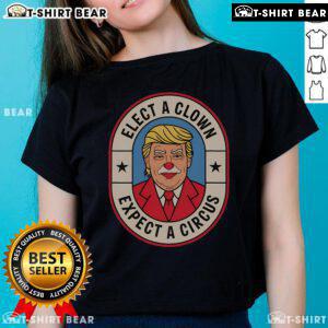 Anti-Trump ladies tee featuring 'Elect A Clown, Expect A Circus' slogan, perfect for political rallies and protests.
