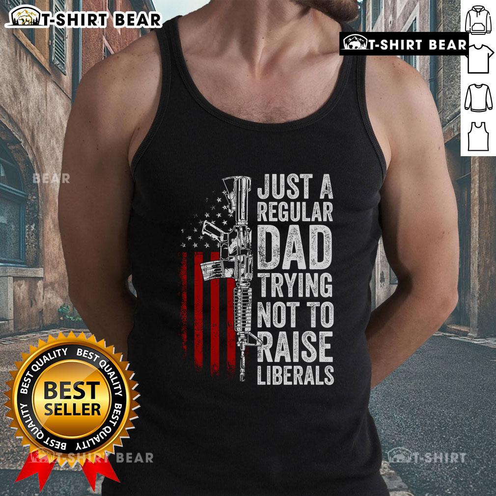 Top Just A Regular Dad Trying Not To Raise Liberals Tank Top showcasing a humorous dad-themed graphic design.